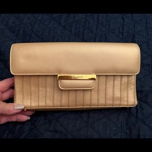 St. John Gold clutch with hidden strap to convert to shoulder bag.